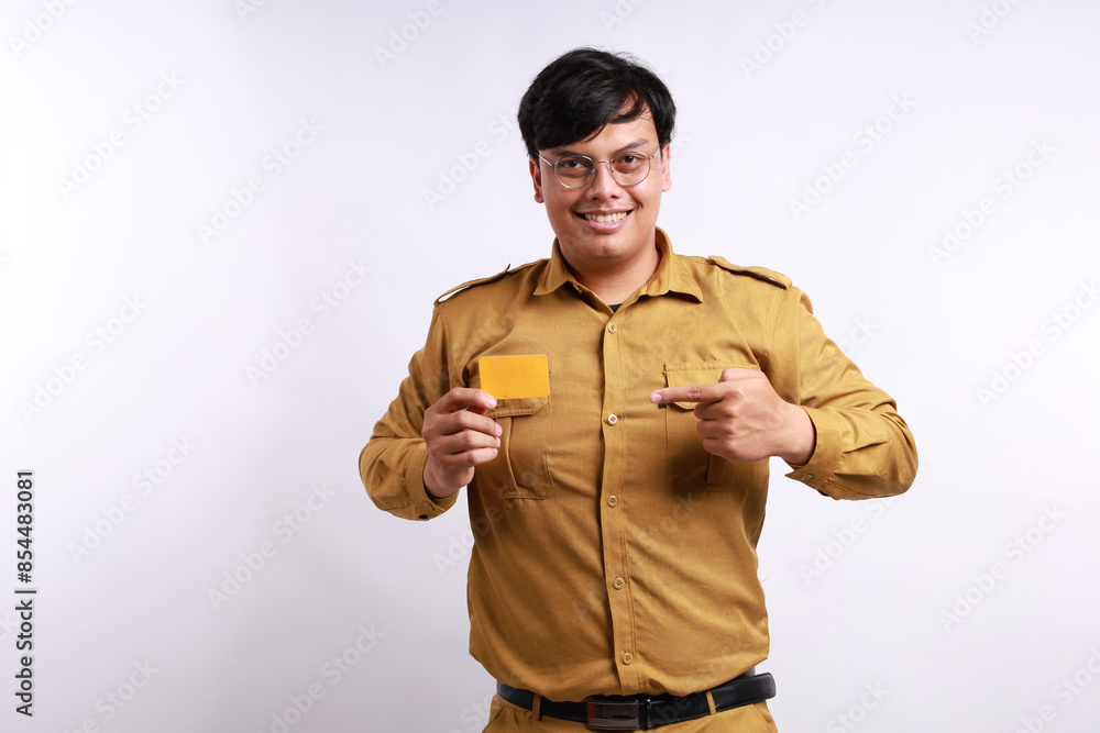 Happy Indonesian government employees standing while holding blank card. Isolated on white background Happy Indonesian government employees standing while holding blank card. Isolated on white background