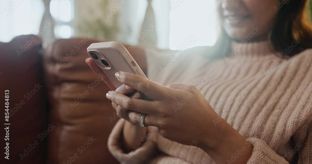 Happy woman, hands and typing with phone on sofa for communication, social media or browsing at home. Closeup of female person with smile on mobile smartphone for online chat, texting or app at house Happy woman, hands and typing with phone on sofa for communication, social media or browsing at home. Closeup of female person with smile on mobile smartphone for online chat, texting or app at house
