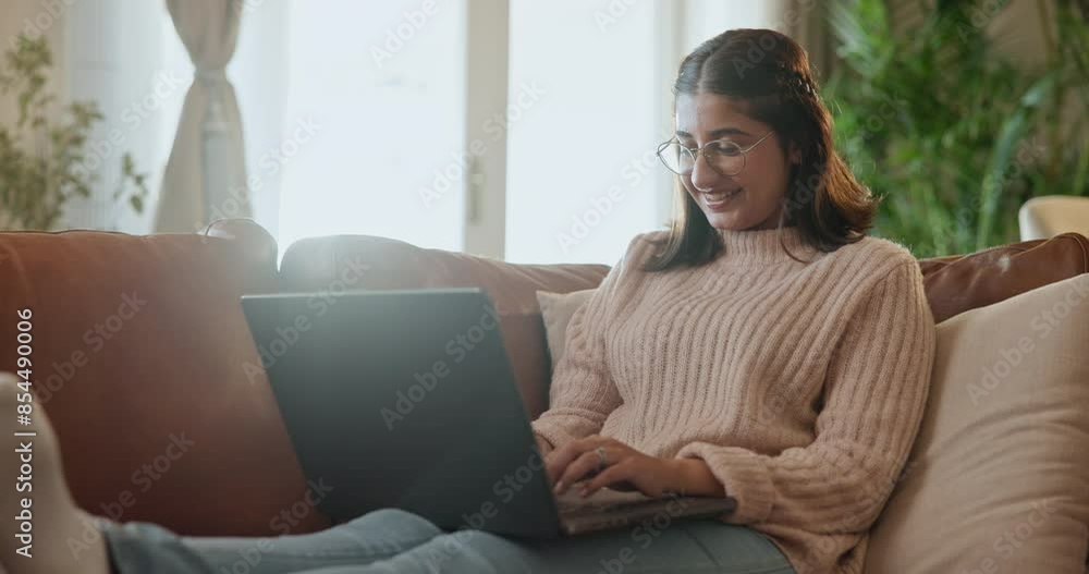 Happy woman, relax and typing with laptop on sofa for online research, browsing or email at home. Female person, student or freelancer with smile on computer for communication or remote work at house