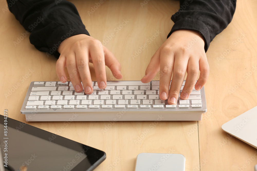 Female programmer typing on computer keyboard in office, closeup Female programmer typing on computer keyboard in office, closeup