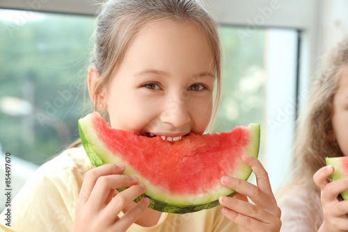Happy young girl eating a l...