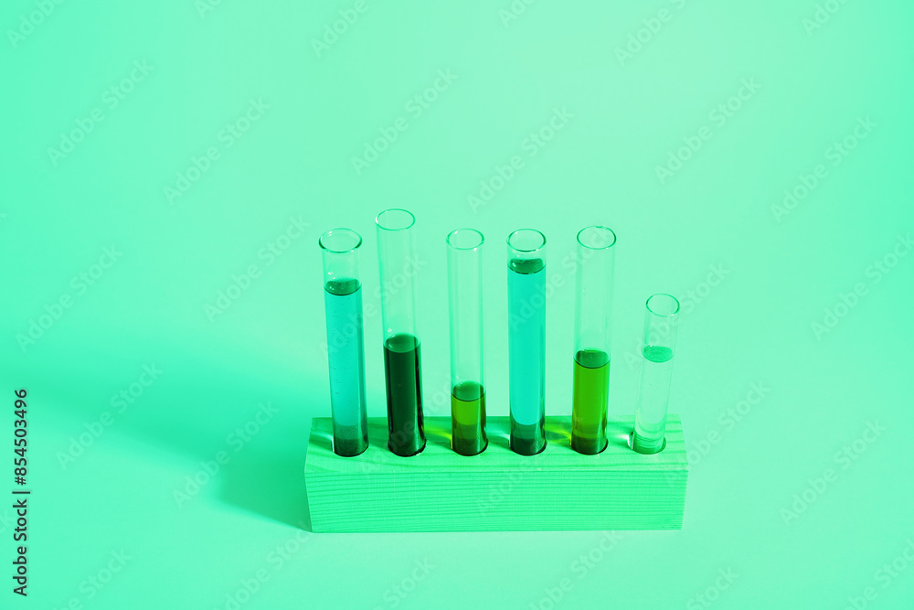 Test tubes with different samples in wooden stand on colorful background Test tubes with different samples in wooden stand on colorful background