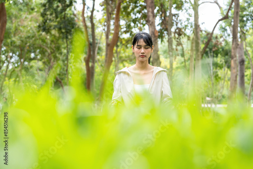 Wallpaper Mural Young woman is meditating at natural park. Torontodigital.ca