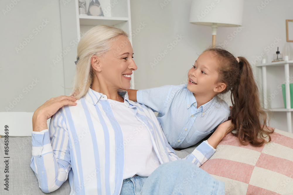 Fototapeta premium Little girl with her grandmother at home