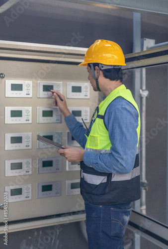 HVAC Technician Checking and Inspecting Control Panel