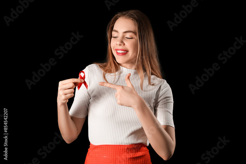 Young woman with red ribbon...