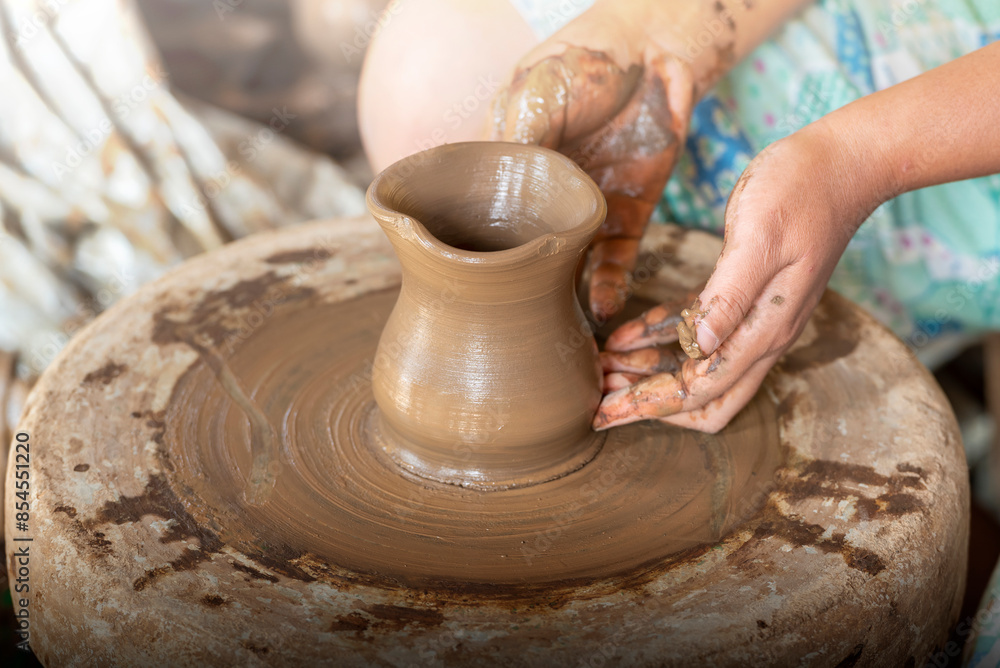 Human hand sculpting a craft from raw clay Human hand sculpting a craft from raw clay