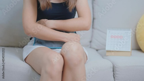 Menstruation period cycle of monthly and Stomachache concepts. woman having abdomen pain with hot water bottle and calendar, illness female suffer from premenstrual ache and body Health problem