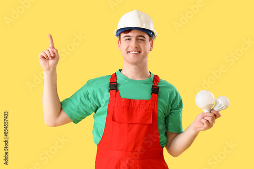 Male electrician with light...