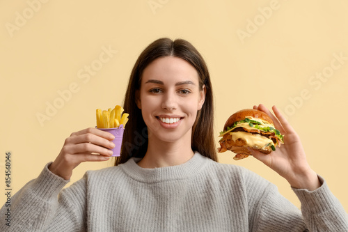 Smiling young woman with ta...