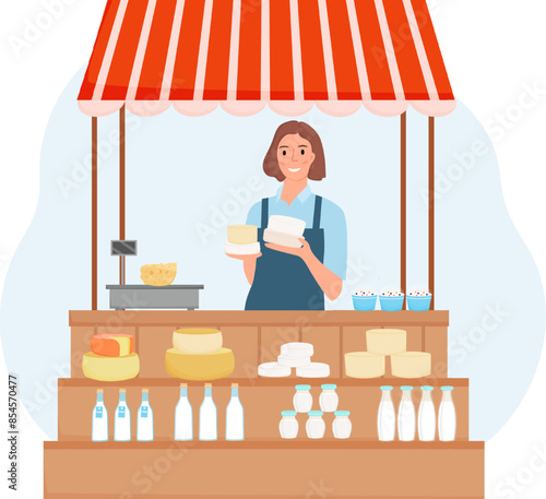 Farmer women sells dairy products. Female farmer stands behind a stall with fresh dairy products as cheese, milk, yogurt. Local market stall. Farmer with farmer products.