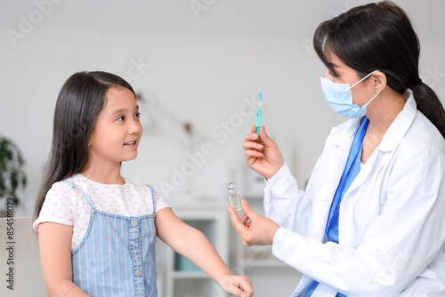 Female doctor with syringe ...
