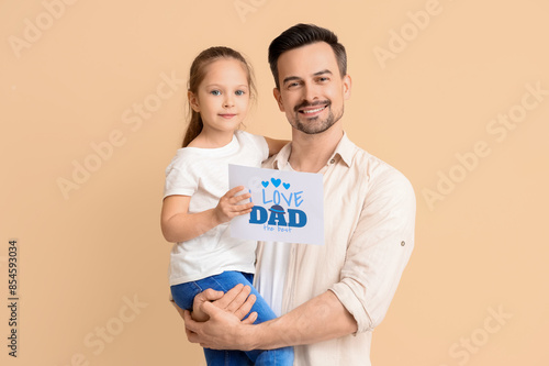 Father and daughter holding...