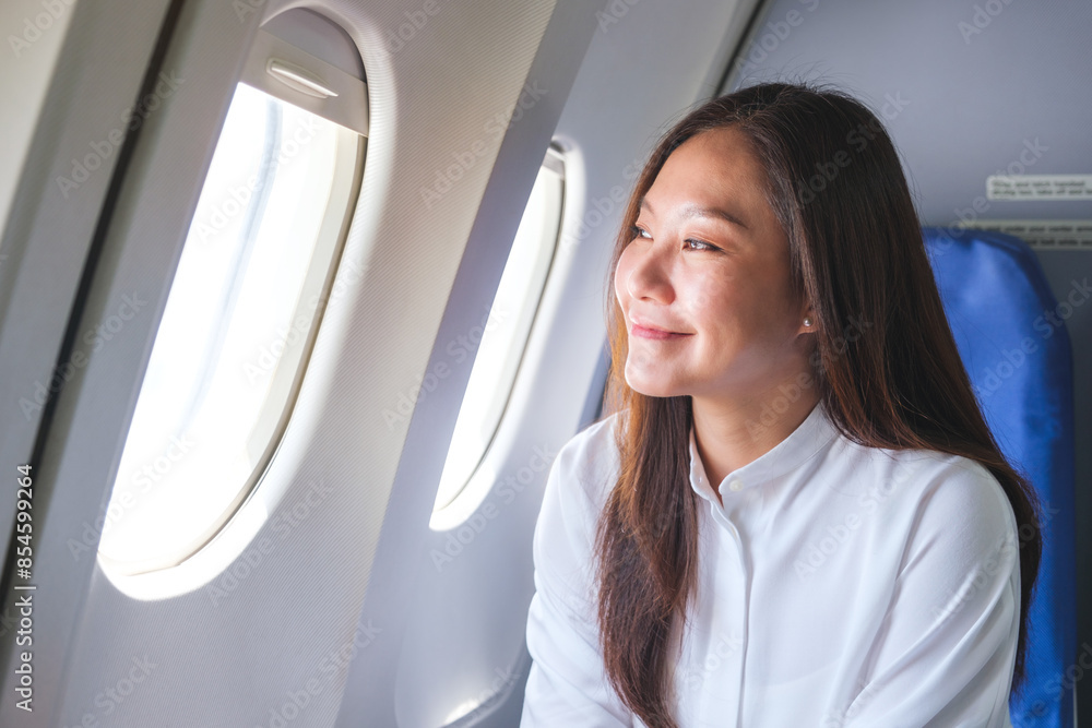 Portrait image of a woman looking through an airplane window Portrait image of a woman looking through an airplane window