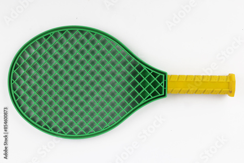 Green tennis racket with yellow handlefor children isolated white background