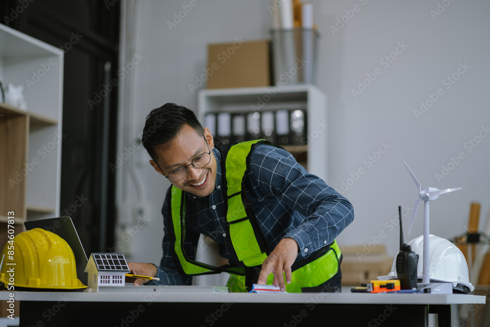 Male designer in office working on architects project. Male designer in office working on architects project.