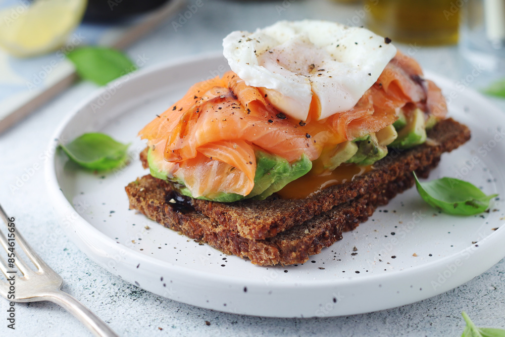 A rye bread sandwich with avocado and salmon A rye bread sandwich with avocado and salmon