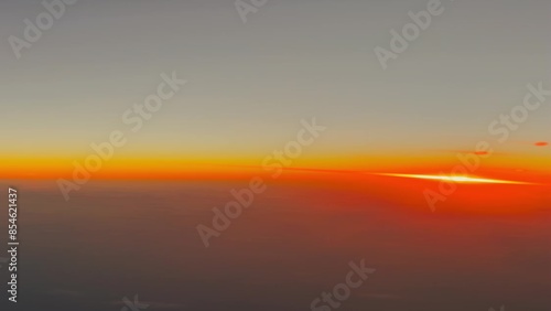 Vertical video from an airplane above the clouds at sunset, real time video, travel time
