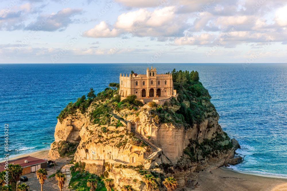 sea landscape of beautiful white temple or castle on a high cliff isle on a rock in crystal clear turquoise sea with waves and beautiful sunset or sunrise on background of seascape sea landscape of beautiful white temple or castle on a high cliff isle on a rock in crystal clear turquoise sea with waves and beautiful sunset or sunrise on background of seascape