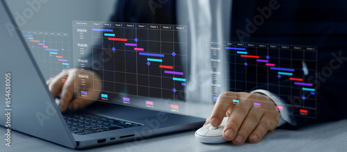 Project manager updating tasks and milestones progress planning with Gantt chart scheduling interface for company.Business Project Management System. photo