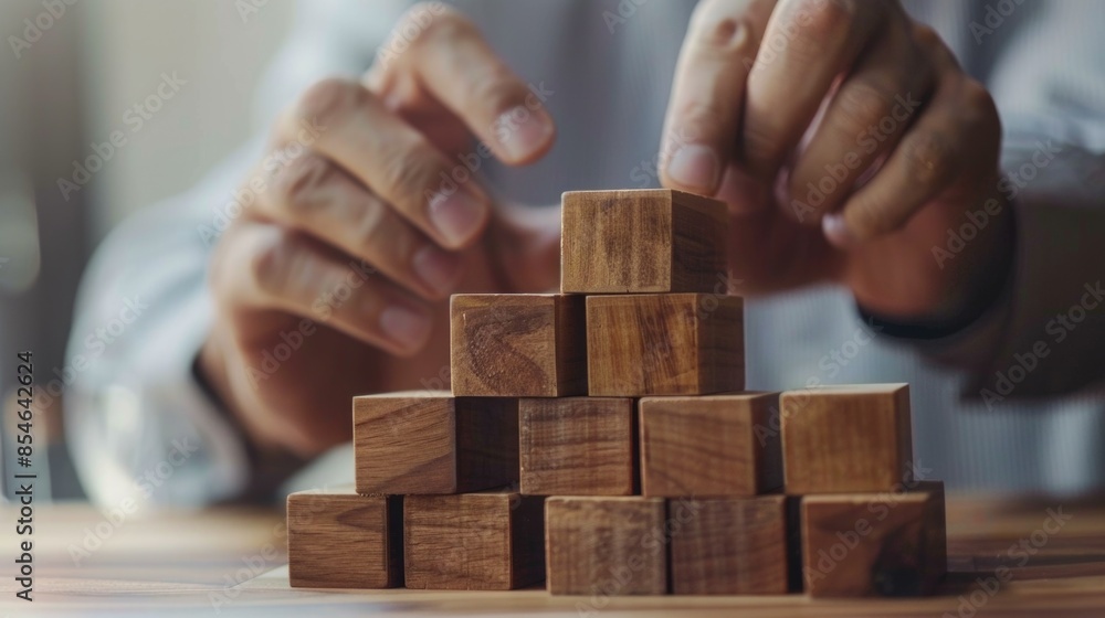 A person places wooden blocks on a table, great for illustration and design A person places wooden blocks on a table, great for illustration and design