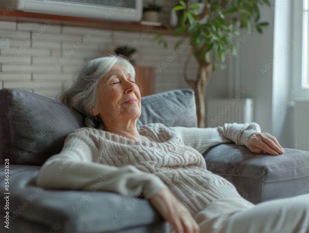 A person relaxing on a couch with their eyes closed A person relaxing on a couch with their eyes closed