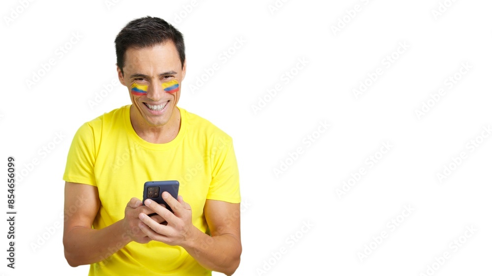 Colombian supporter looking at his mobile smiling and showing it. Colombian supporter looking at his mobile smiling and showing it.