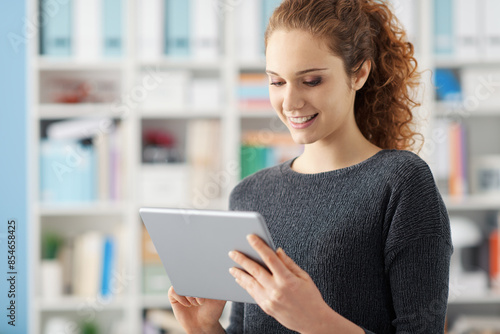 Young woman connecting with a digital tablet © StockPhotoPro