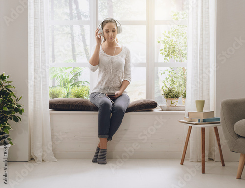 Free Download Relaxed woman listening to music at home - GFXLoad