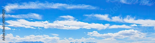 Photograph of a vast expanse of blue sky with wispy cirrus clouds, creating a sense of tranquility and peace.