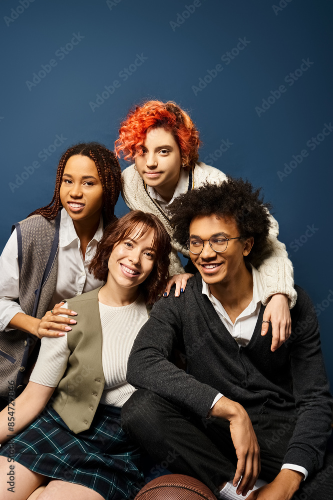 A group of young friends, sitting together in stylish attire on a dark blue background. A group of young friends, sitting together in stylish attire on a dark blue background.
