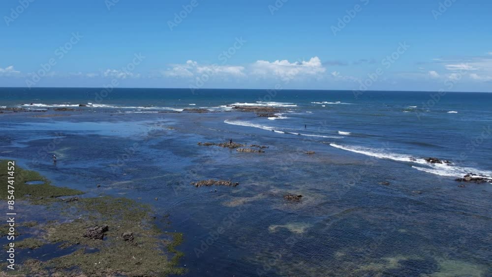 Flying above corals with people fishing during low tide Flying above corals with people fishing during low tide