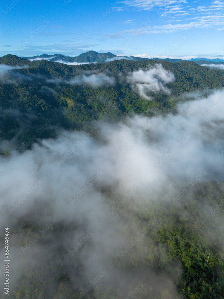 A high-angle landscape, dense fog, natural forest mountains covered in fog. A bright sky and beautiful landscape can be viewed from the sky with a drone. A high-angle landscape, dense fog, natural forest mountains covered in fog. A bright sky and beautiful landscape can be viewed from the sky with a drone.