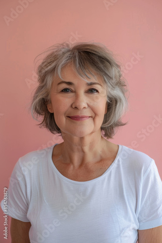 A woman with short gray hair is smiling for the camera