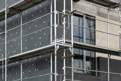 insulating the walls with modern thermal insulation materials. The new house construction process involves Exterior covering is applied at the construction site.