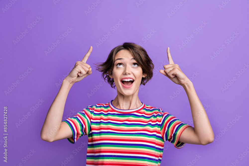 Portrait of amazed lady indicating fingers up empty space billboard ad ads adv isolated purple color background Portrait of amazed lady indicating fingers up empty space billboard ad ads adv isolated purple color background