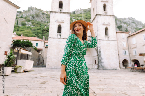 Young beautiful woman in trendy summer dress posing in street. Fashion style.Tourist attraction. Vacation and travel concept.