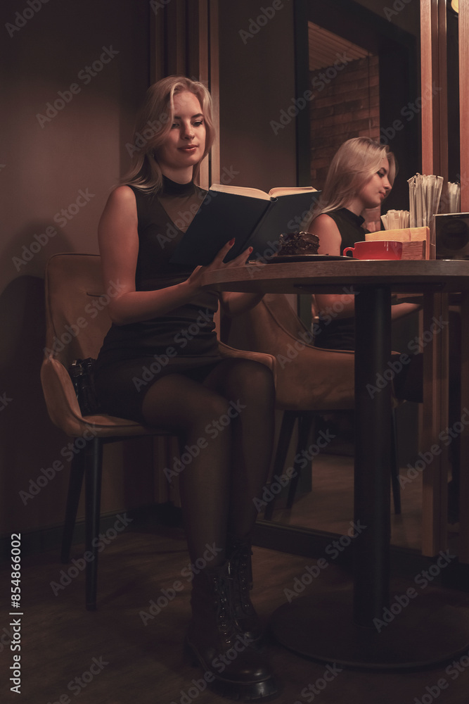 A girl is relaxing in a cafe, reading a book with a cup of coffee. A girl is relaxing in a cafe, reading a book with a cup of coffee.