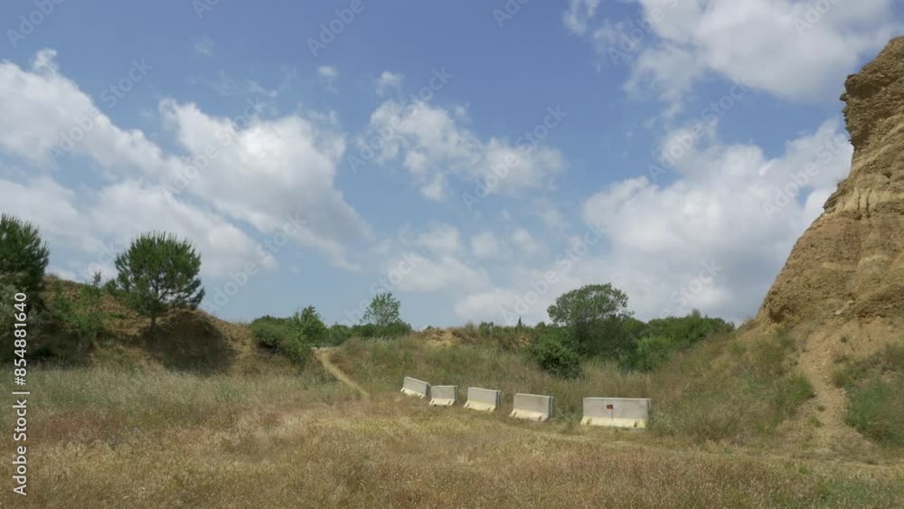 Wide shot of some curious dirt knolls that were left long ago in the suburbs of Terrassa to hold power lines Wide shot of some curious dirt knolls that were left long ago in the suburbs of Terrassa to hold power lines