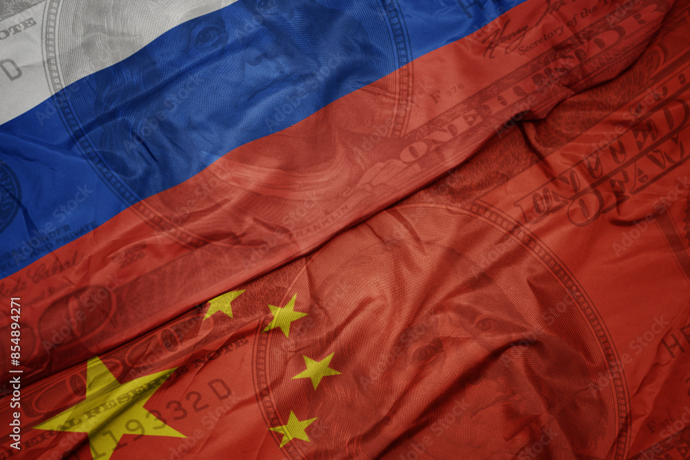 waving colorful flag of russia and national flag of china on the dollar money background. finance concept. waving colorful flag of russia and national flag of china on the dollar money background. finance concept.