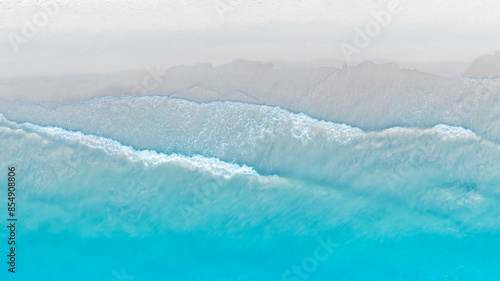 Fototapeta Naklejka Na Ścianę i Meble -  Tropical Beach with the soft wave water of the sea on the sandy beach background as texture with splashes and bubbles