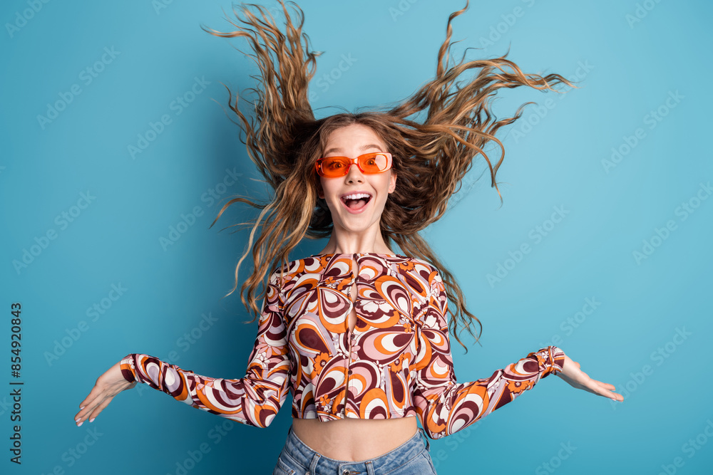 Φωτογραφία Photo of nice young girl throw hair wear top isolated on blue color background