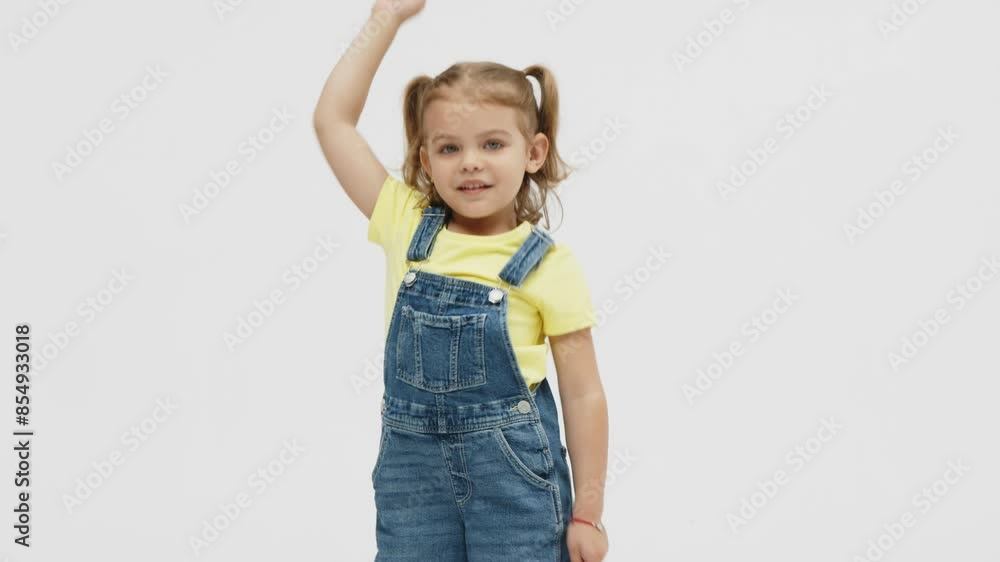 Fashionable, stylish little blonde girl dancing, having fun and posing on a white studio background. Fashion, children's clothing and entertainment concept. Fashionable, stylish little blonde girl dancing, having fun and posing on a white studio background. Fashion, children's clothing and entertainment concept.