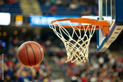 Basketball going through the hoop during a game, capturing the excitement and action of the sport in a dynamic moment.