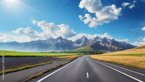 Asphalt road and mountain nature landscape under blue sky
