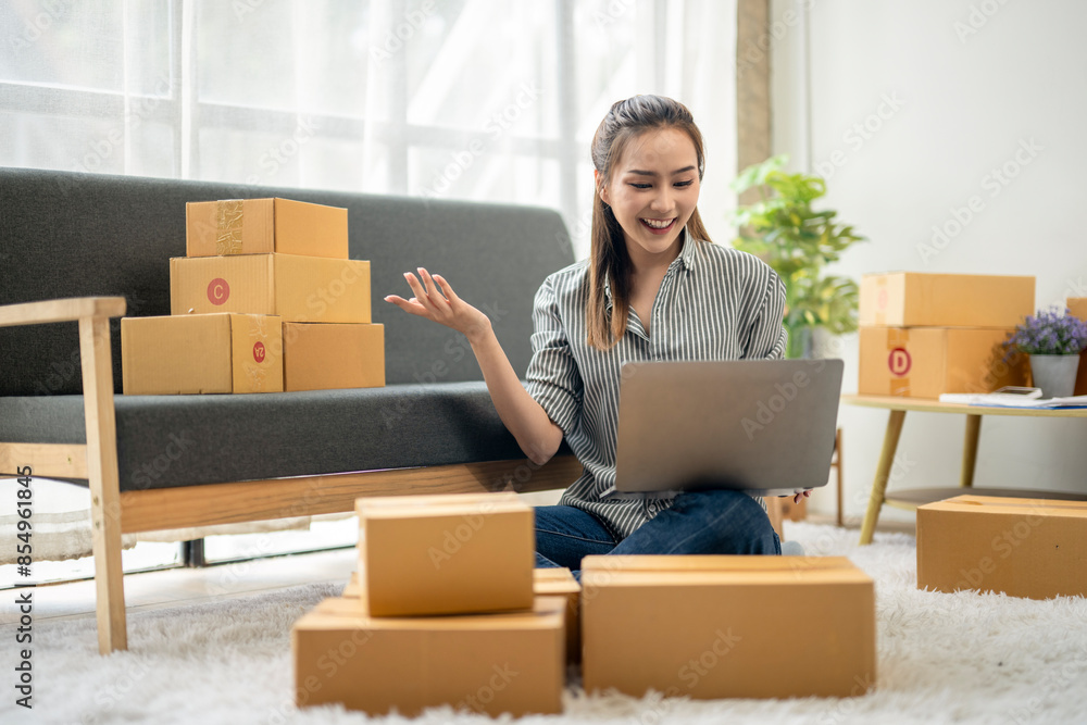 A woman is sitting on the floor in front of a couch and a pile of boxes A woman is sitting on the floor in front of a couch and a pile of boxes