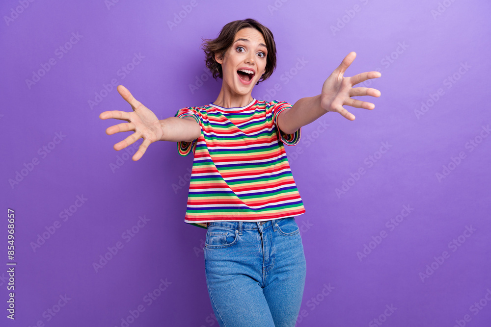 Portrait of astonished cheerful girl raise opened arms welcome invite you isolated on purple color background Portrait of astonished cheerful girl raise opened arms welcome invite you isolated on purple color background