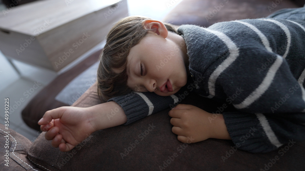 Peaceful Nap Time - Young Boy Asleep on a Cozy Sofa in a Striped Sweater Peaceful Nap Time - Young Boy Asleep on a Cozy Sofa in a Striped Sweater