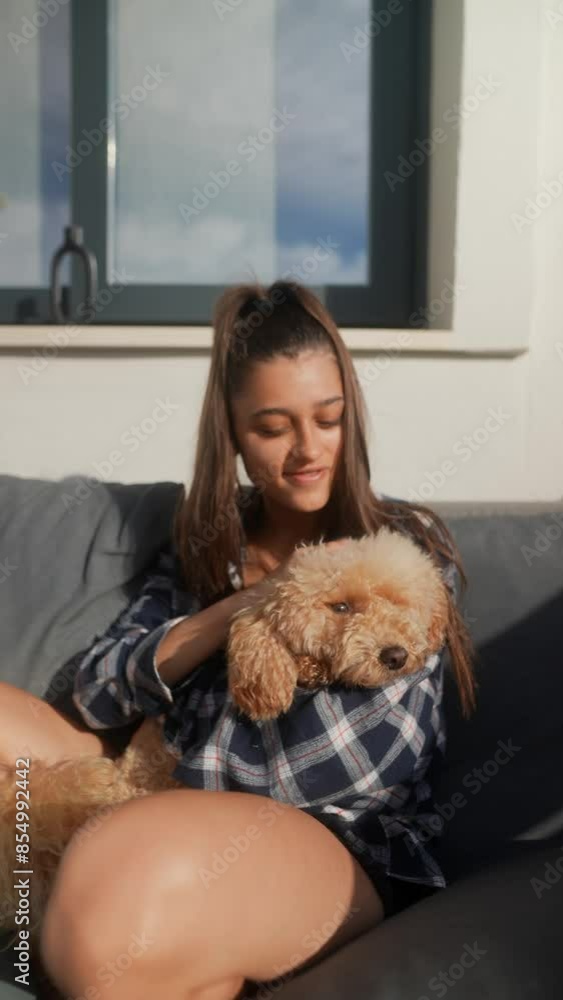 A young woman shows love to her dog outdoors on a sunny day, sharing a warm moment of companionship A young woman shows love to her dog outdoors on a sunny day, sharing a warm moment of companionship