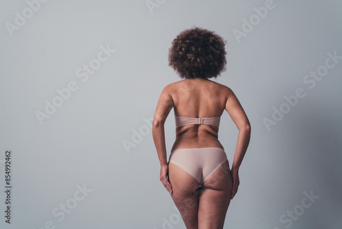 Unretouched photo of girl stand back with fat folds feel comfortable in new brand fashion lingerie photo